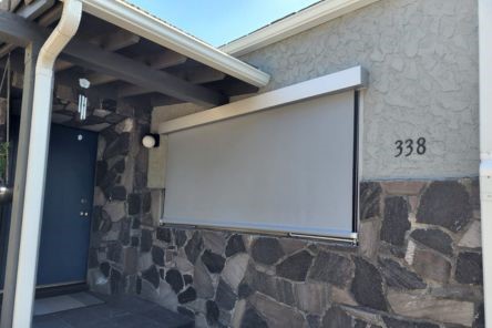 Motorized window shades covering large windows on the front facade of a home in Oakland, highlighting sleek design and advanced shading system.